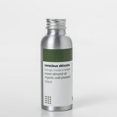 Sweet almond oil in silver metal bottle with green and white label, Conscious Skincare brand