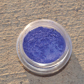 Small round jar of pigmented Spyro mineral eyeshadow with black sifter lid and vibrant purple powder
