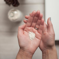 Powder in hands, light beige color, fine texture, held in open palms