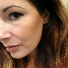 Eye makeup with black eyeliner, brown eye color, and brown hair with highlights