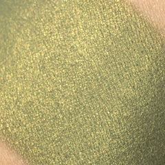 Green eyeshadow swatch with shimmery finish and crosshatch pattern on skin