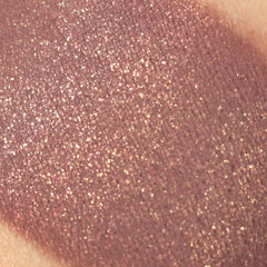 Side view of burgundy plum and copper shimmer vegan mineral eyeshadow in compact, showcasing metallic finish and texture.