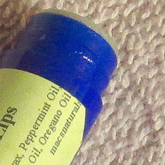 Blue lip balm tube with green label and textured white background