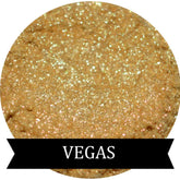 Close-up of sparkling gold eye shadow in a round compact with reflective surface and shimmer particles