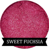 Close-up of Sweet Fuchsia mineral eyeshadow in compact with shimmering pink pigment and satin finish