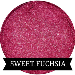 Close-up of Sweet Fuchsia mineral eyeshadow in compact with shimmering pink pigment and satin finish