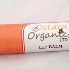 Lip balm, orange tube with white label, "Ostara Organics" text visible, for lips
