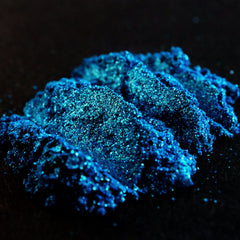 Vibrant teal shimmer loose mineral eyeshadow with turquoise and green glitter in a clear sifter jar