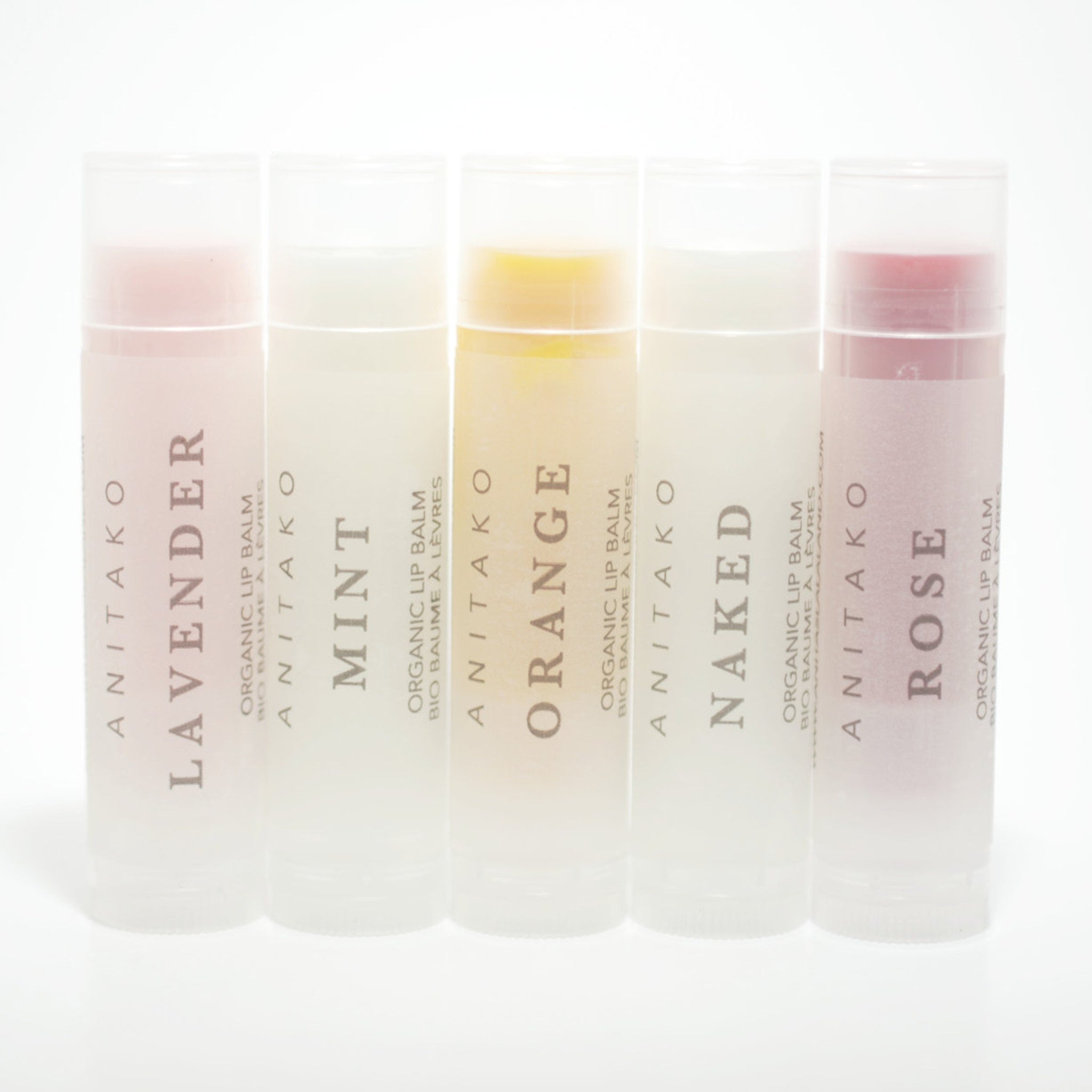 Lip balms in clear tubes with ANITAKO text, various colored balms, and white background