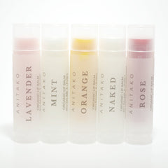 Lip balms in clear tubes with ANITAKO text, various colored balms, and white background