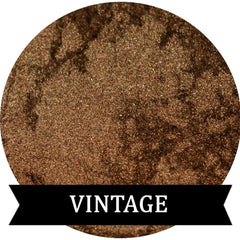 Close-up of Vintage Mineral Eyeshadow in rich dark gold with shimmering metallic finish, displayed in compact case.