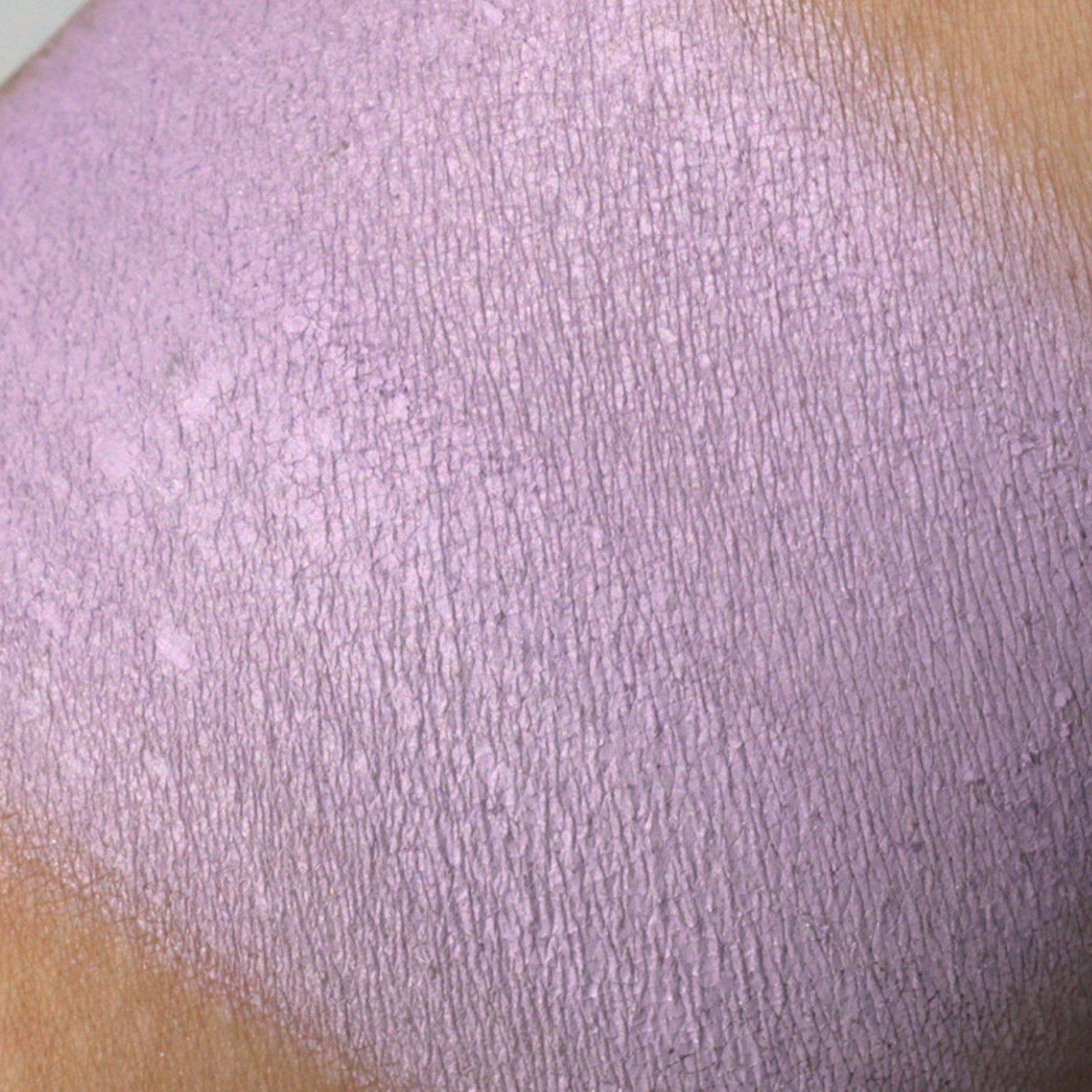Purple textured material swatch on skin, showing color and surface detail