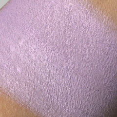 Purple textured material swatch on skin, showing color and surface detail