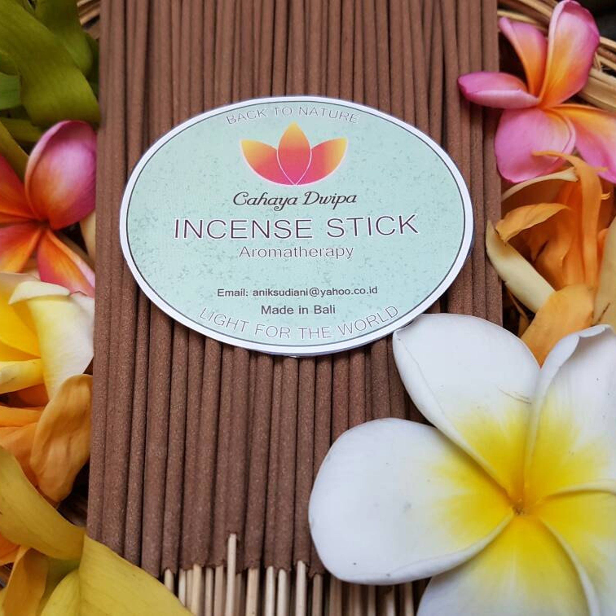 Incense sticks brown sticks with Cahaya Dwipa label and floral background for aromatherapy