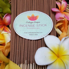 Incense sticks brown sticks with Cahaya Dwipa label and floral background for aromatherapy