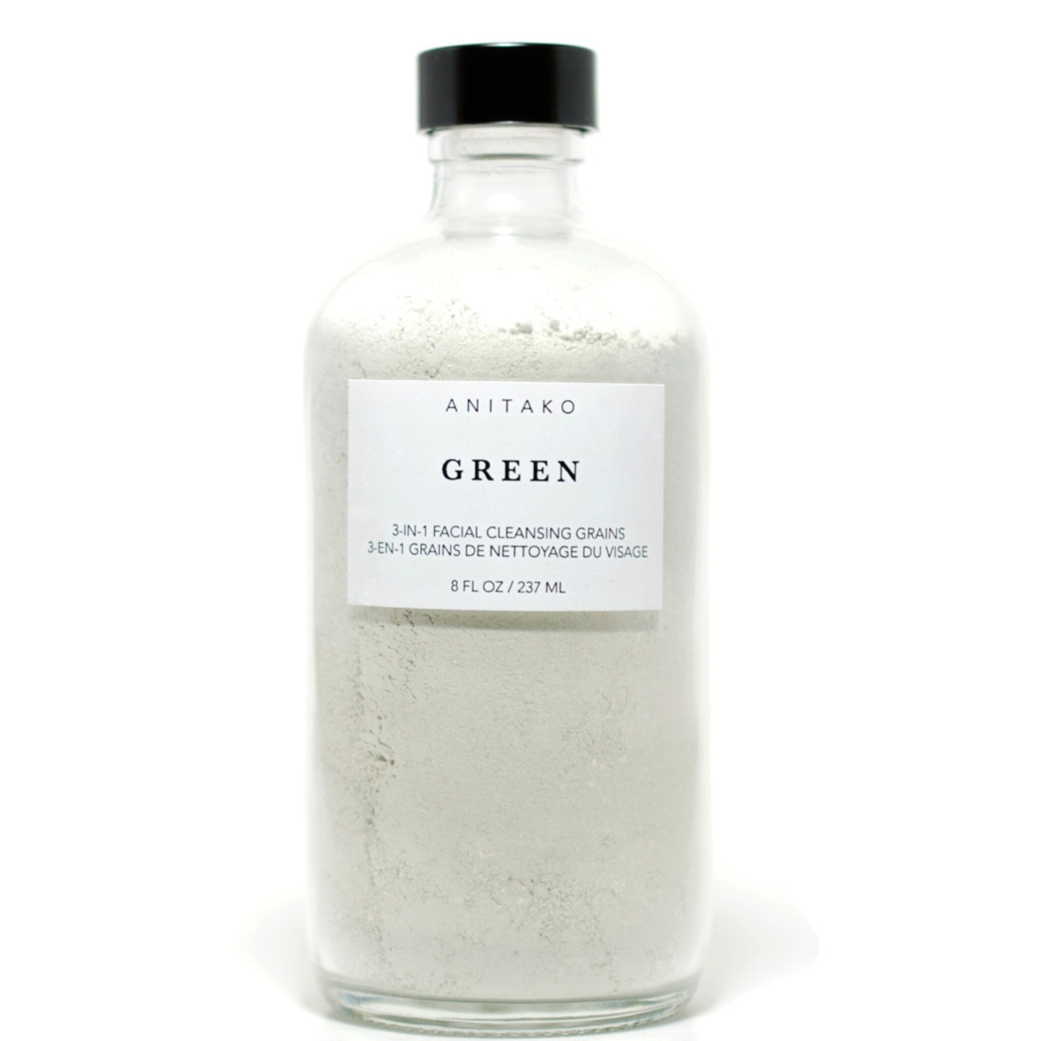 Facial cleansing grains in a clear glass bottle with black cap, ANITAKO ORGANICS label