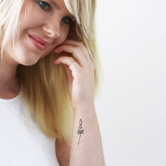 Close-up of boho unalome temporary tattoo set on skin, showcasing intricate henna-style designs in dark brown.