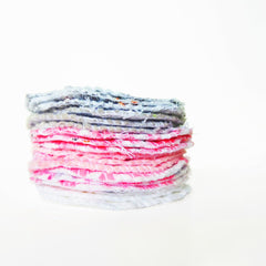Reusable face pads in pink and white floral patterns, stacked together