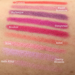 Lipstick swatches in various colors, including crimson, pink, and purple, on skin