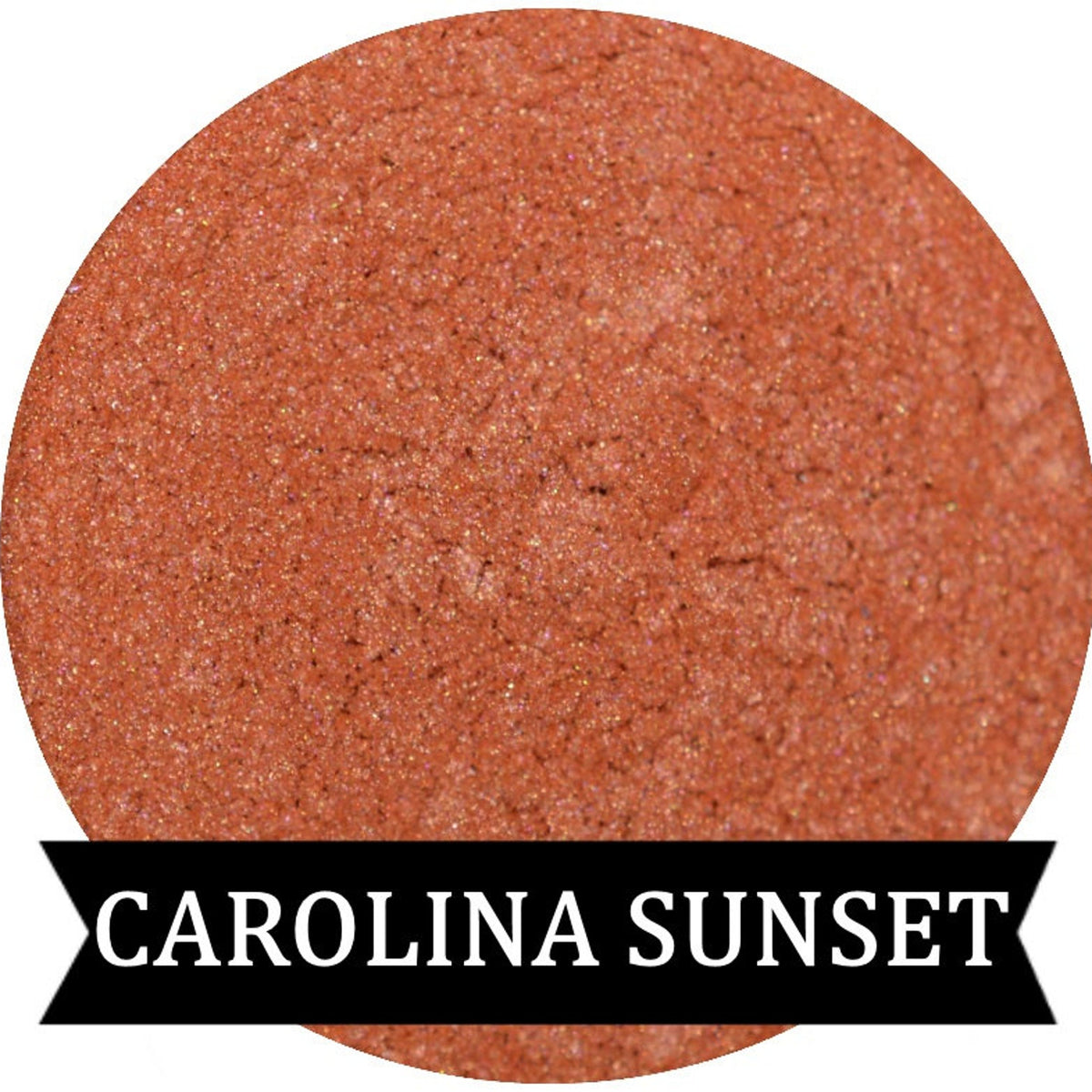Close-up of Coral Sunset eyeshadow pan with vibrant pink shimmer and warm orange undertones