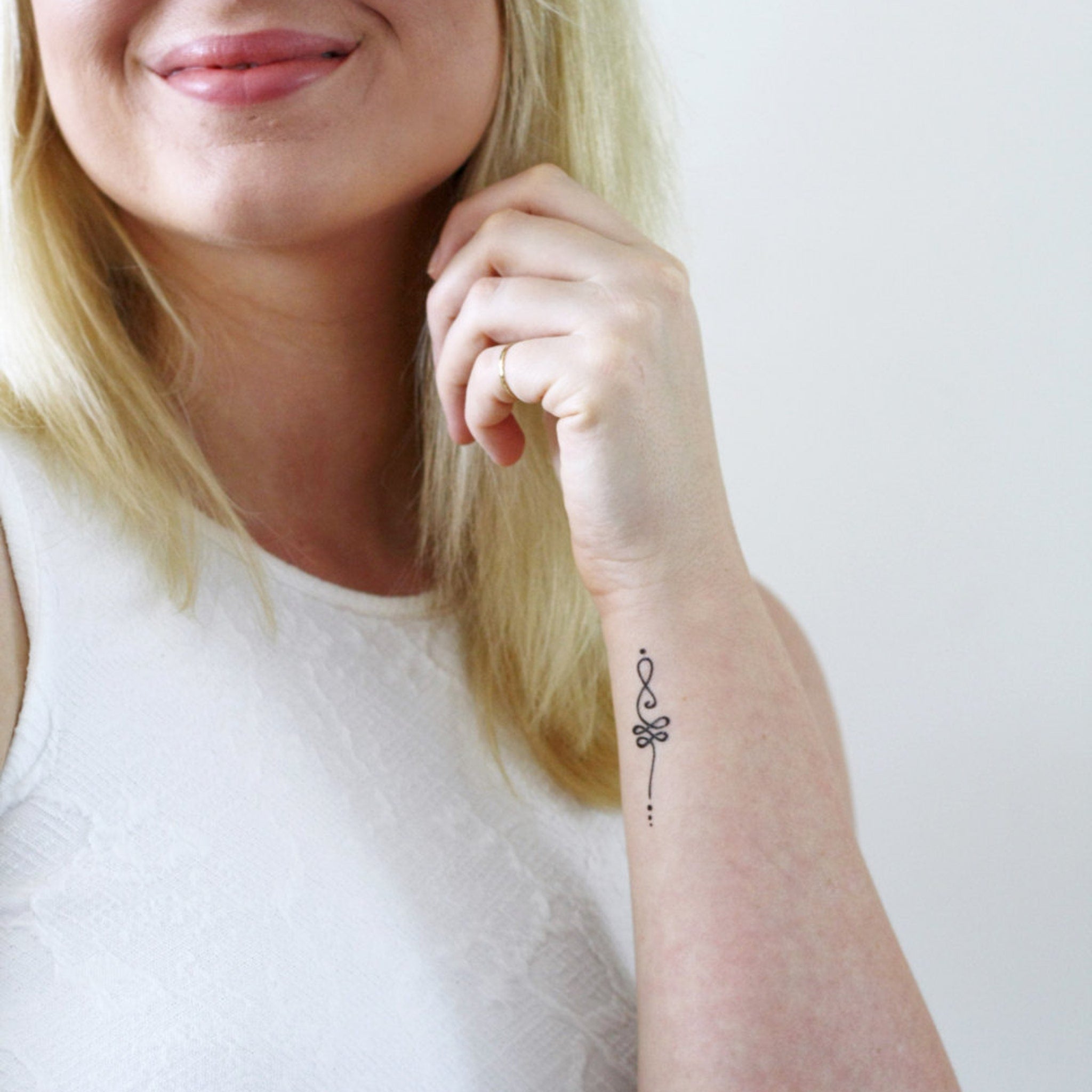 Close-up of boho unalome temporary tattoo set with delicate designs on skin-safe adhesive sheets, gift-ready packaging