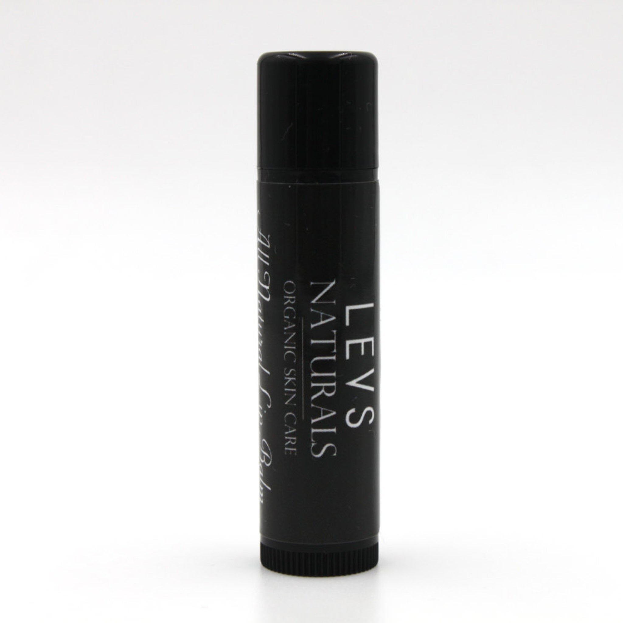 Lip balm tube, black plastic with white text, "LEVS NATURALS" visible on the side