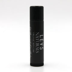 Lip balm tube, black with white text, LEVS NATURALS branding, cylindrical shape