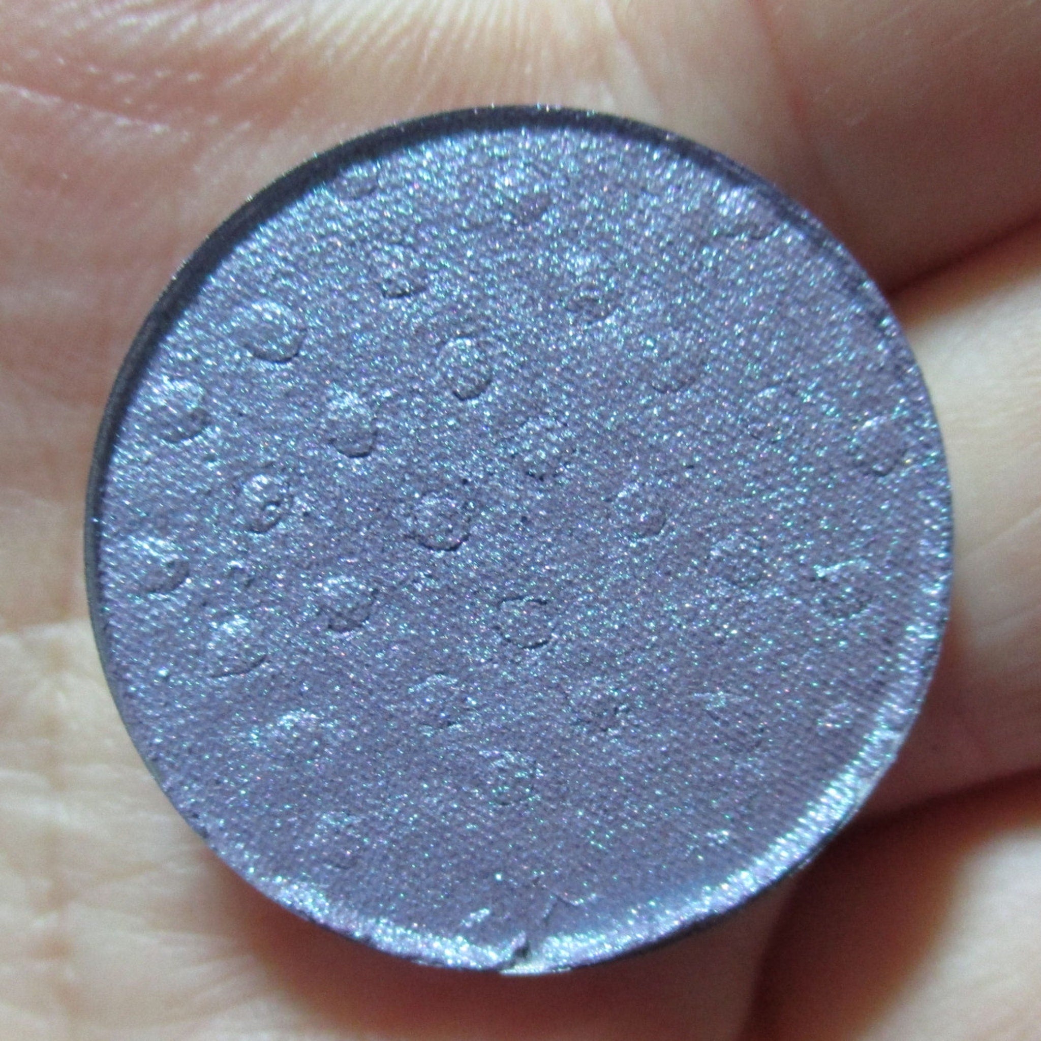 Moonlight Masquerade Eye Shadow palette with shimmering silver, deep navy, and matte black shades in sleek black compact