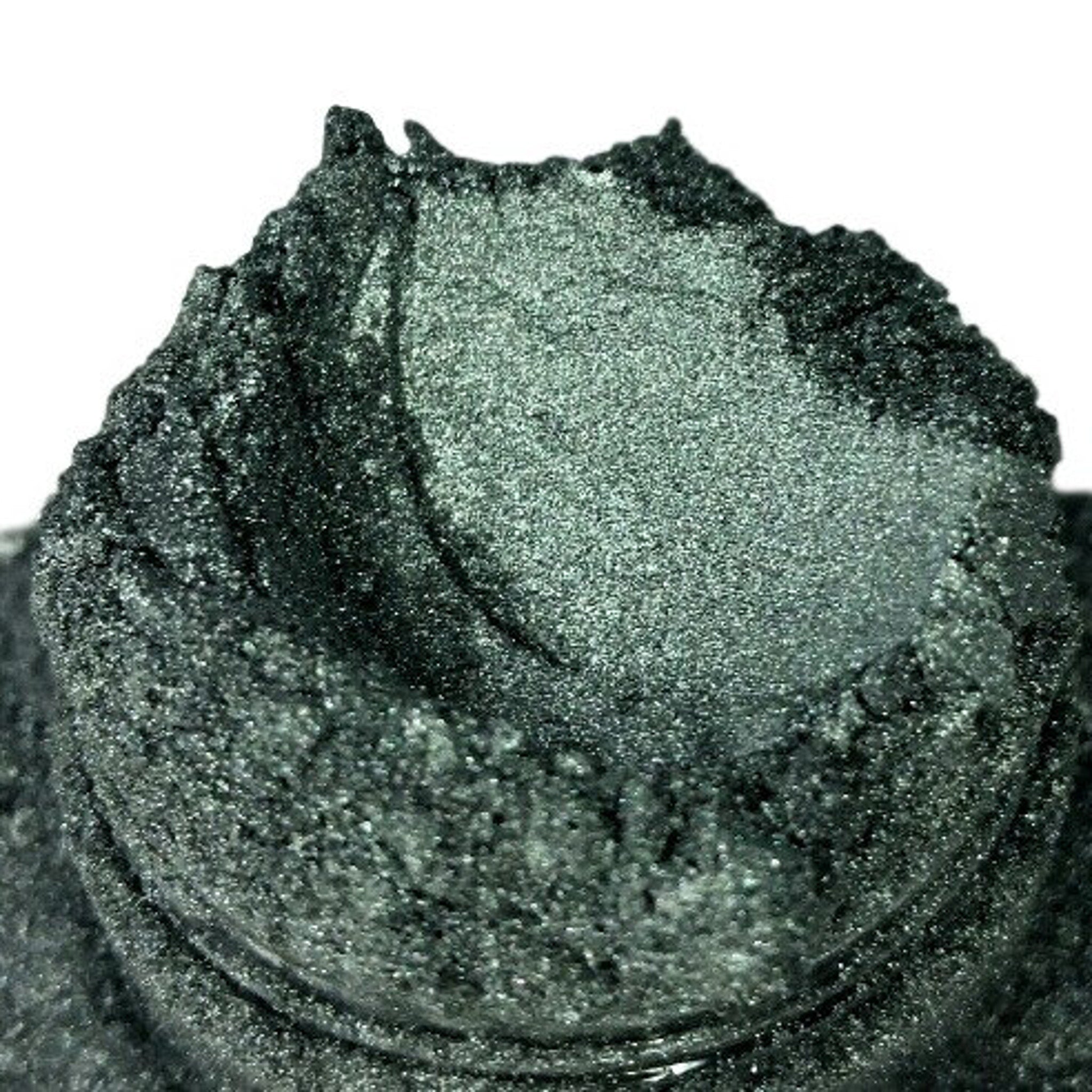 Glittery green pigment in a textured mound, showing fine particles and a metallic sheen