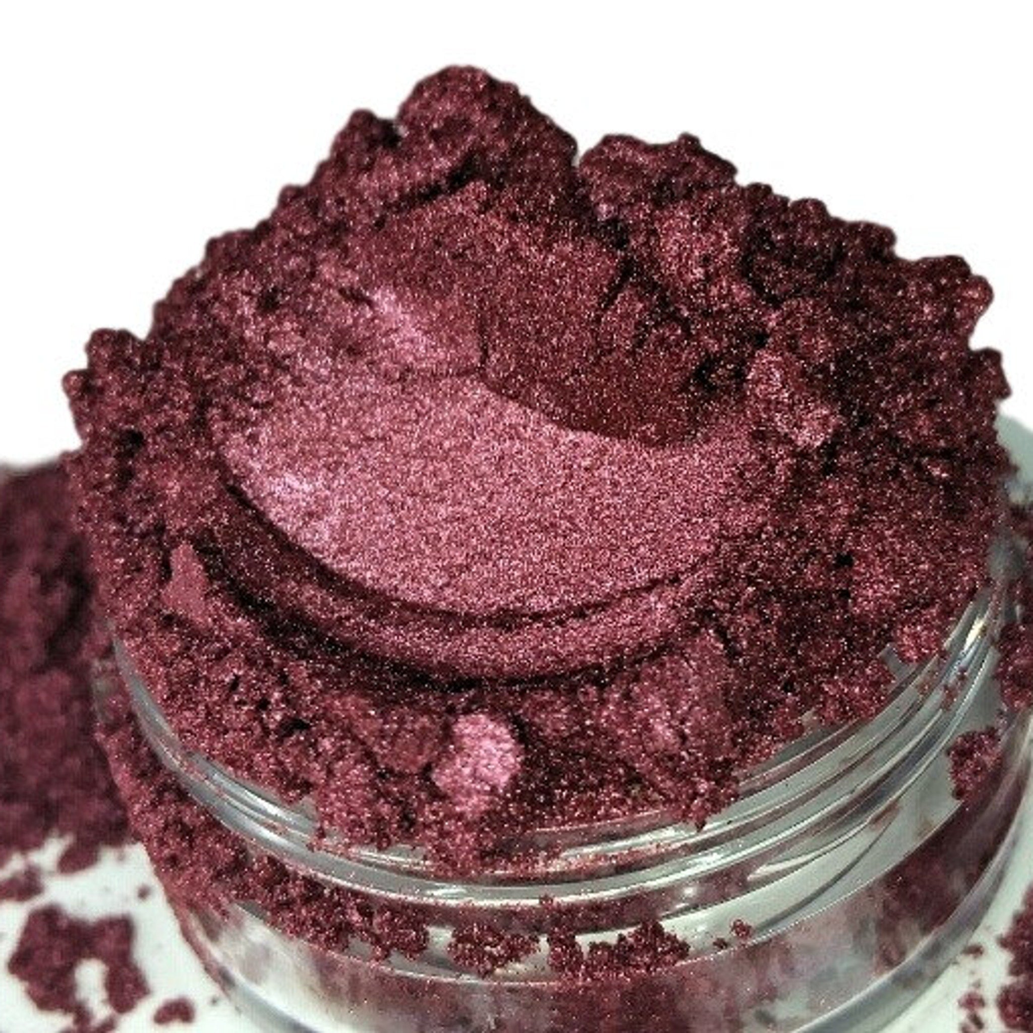 Burgundy red raspberry vegan eyeshadow in a sifter jar with mineral luster finish, showcasing rich pigment texture.