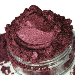 Burgundy red raspberry vegan eyeshadow in a sifter jar with mineral luster finish, showcasing rich pigment texture.
