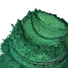 Mineral eyeshadow, hunter green powder with textured surface and visible lines