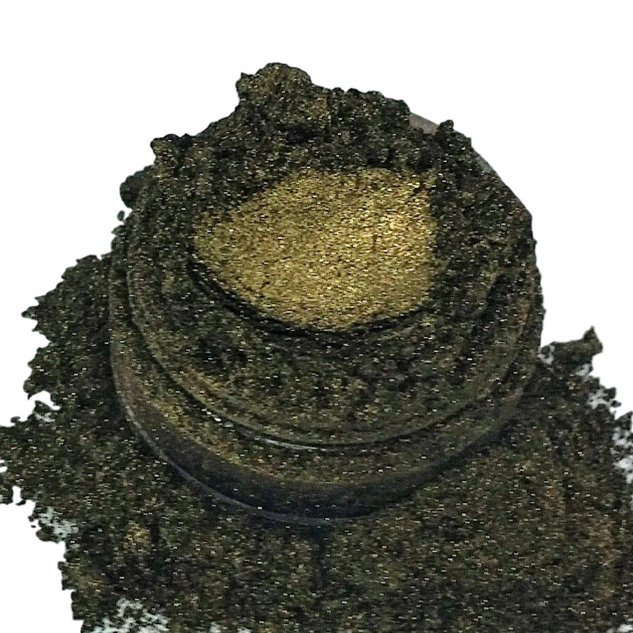 Eyeshadow, dark green and gold shimmer, loose powder texture in a jar
