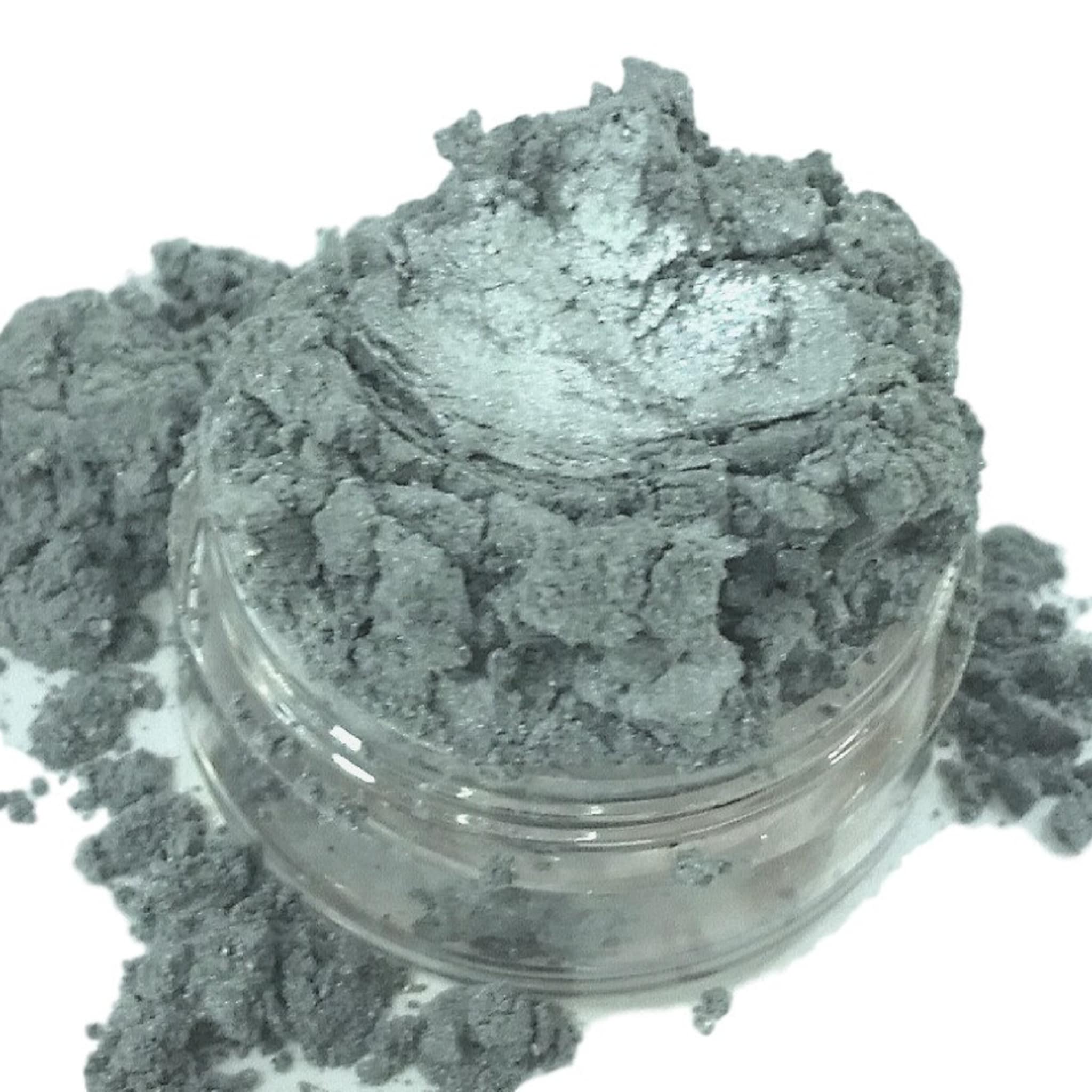 Close-up of vibrant purple and blue mineral eyeshadow pan showing shimmering mica particles