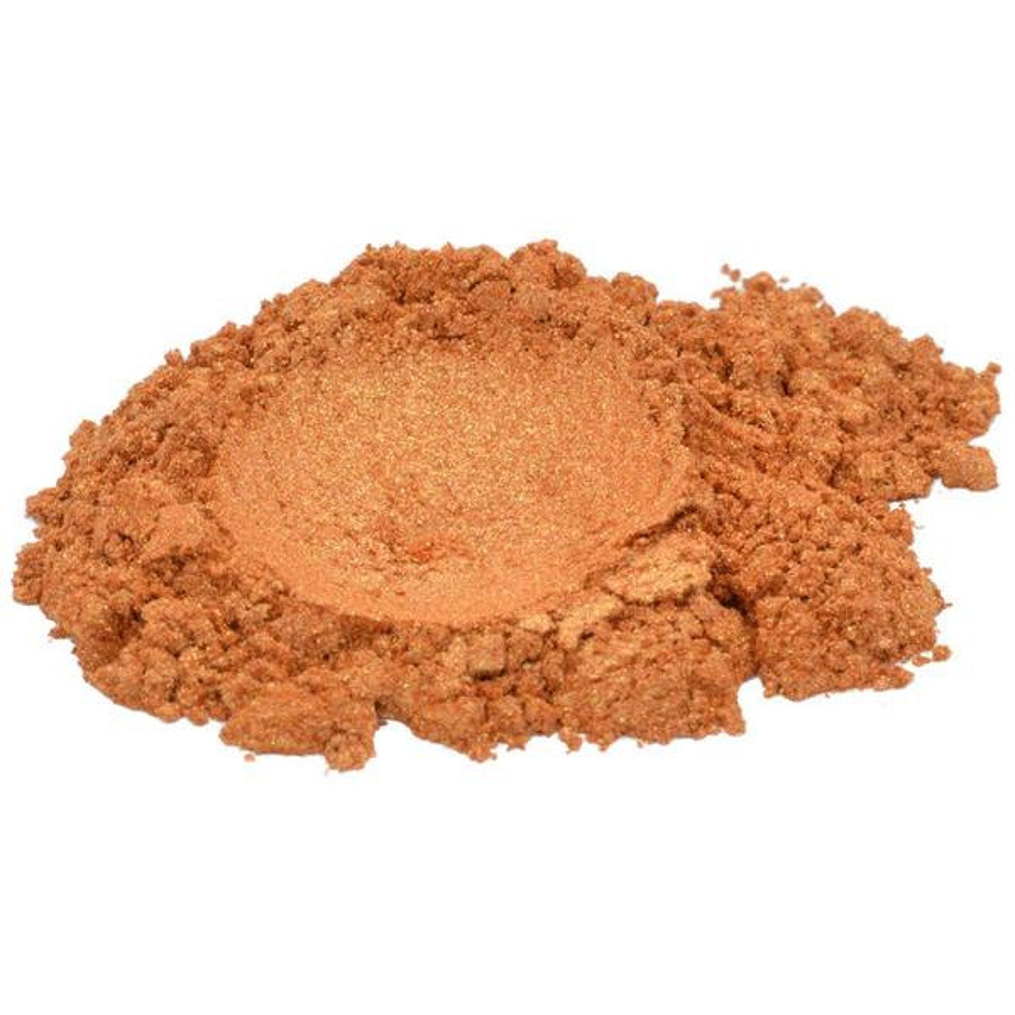 Orange powder with metallic sheen, textured appearance, loose pile on white background