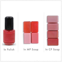 Red nail polish bottle with black cap, and various red and pink soap bars