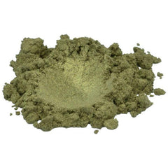 Verdigris gold-green mica pigment powder spilled on marble surface, showcasing shimmering texture and rich color depth.