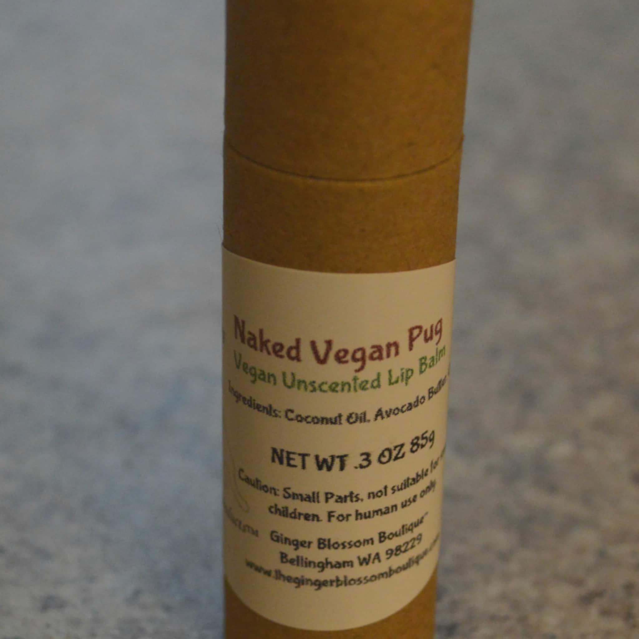 Vegan lip balm in brown cardboard tube with printed label, Naked Vegan Pug brand name visible