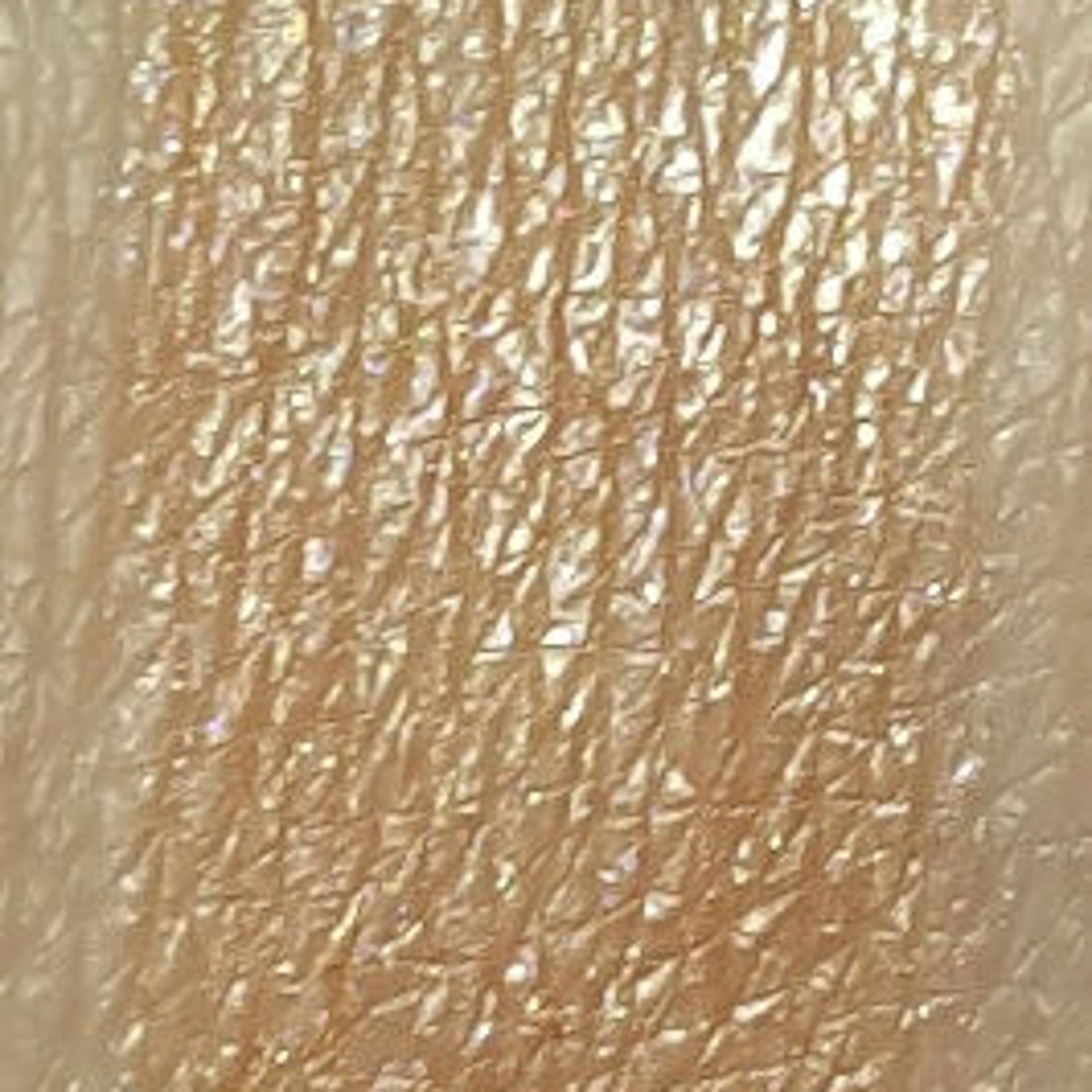Close-up of shimmering gold blush eyeshadow pan with smooth metallic finish and warm undertones