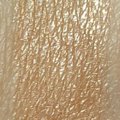 Close-up of shimmering gold blush eyeshadow pan with smooth metallic finish and warm undertones