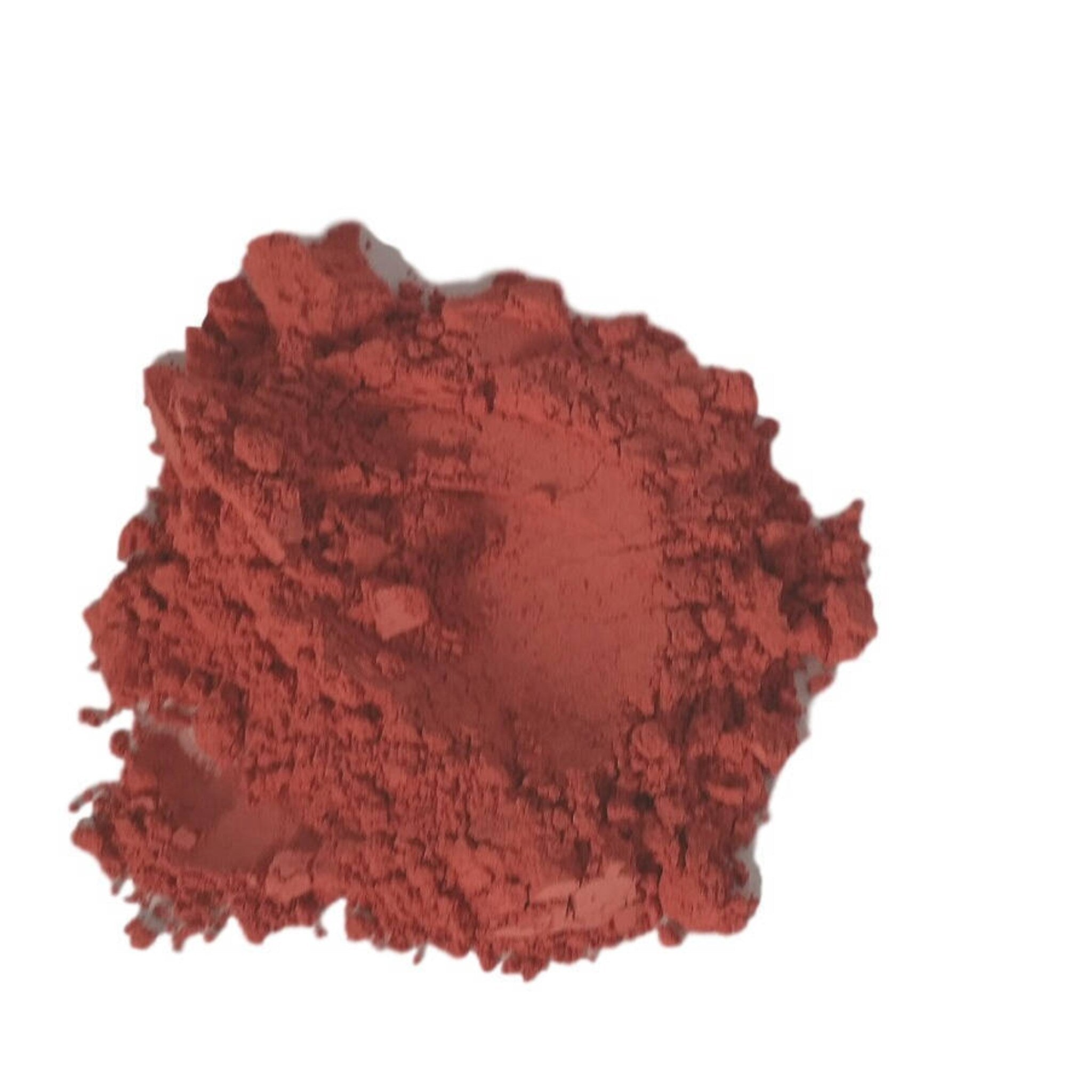 Green matte mineral eyeshadow pot with olive gray pigment on a wooden surface