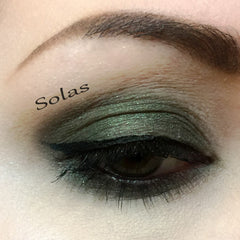 Eye makeup with green eyeshadow, black eyeliner, and Solas brand text on eye