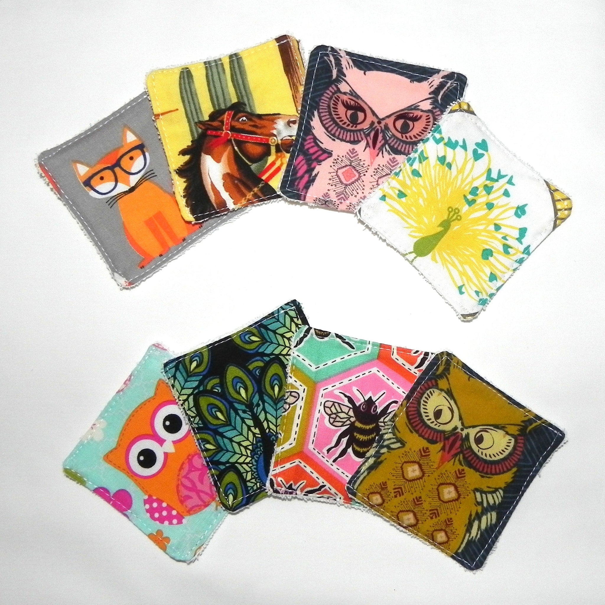 Cloth coasters with animal and pattern designs in various colors and styles