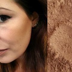 Blush makeup on face, light brown powder, woman's cheek, dark hair