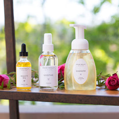 Facial skincare products, clear glass bottles with white labels, yellow liquid, and a black dropper top, with brand text visible