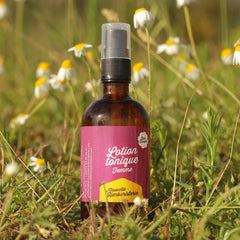 Tonic lotion bottle, brown glass, pink label with text "Lotion tonique Femme" in field