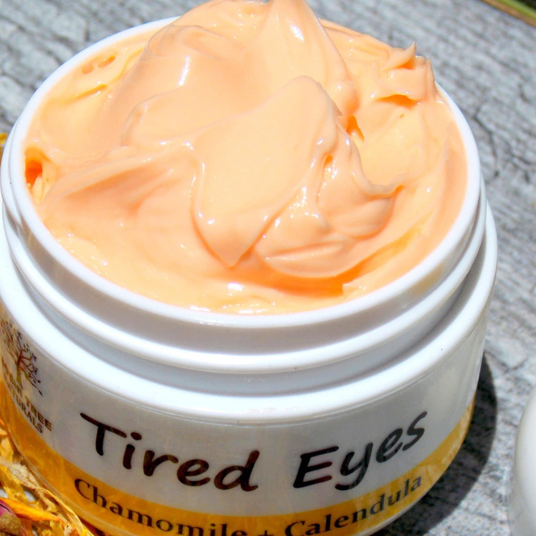 Tired Eyes cream, peach-colored cream, white jar, visible brand text
