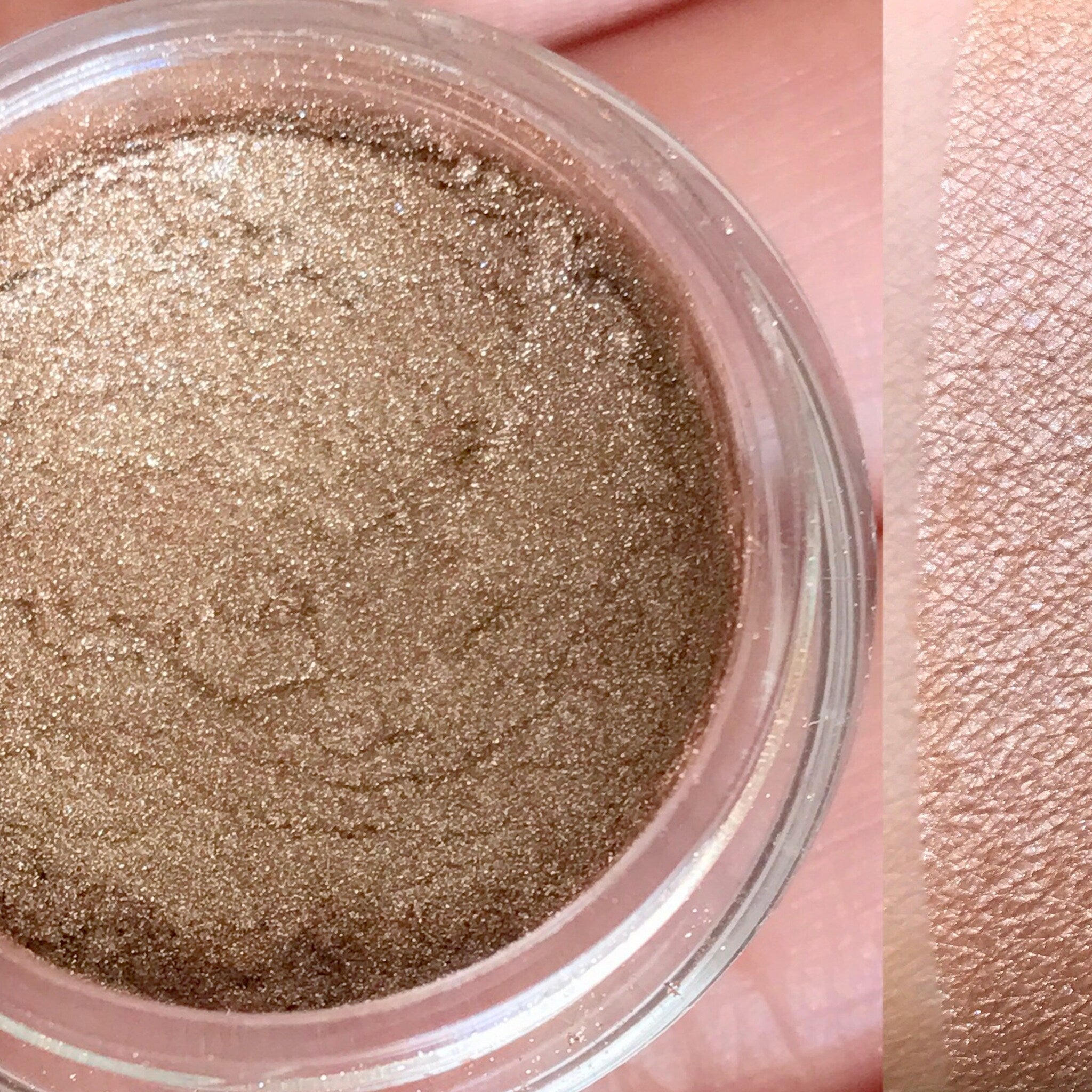 Compact of vegan mineral eyeshadow in shimmering neutral tones with sleek black packaging