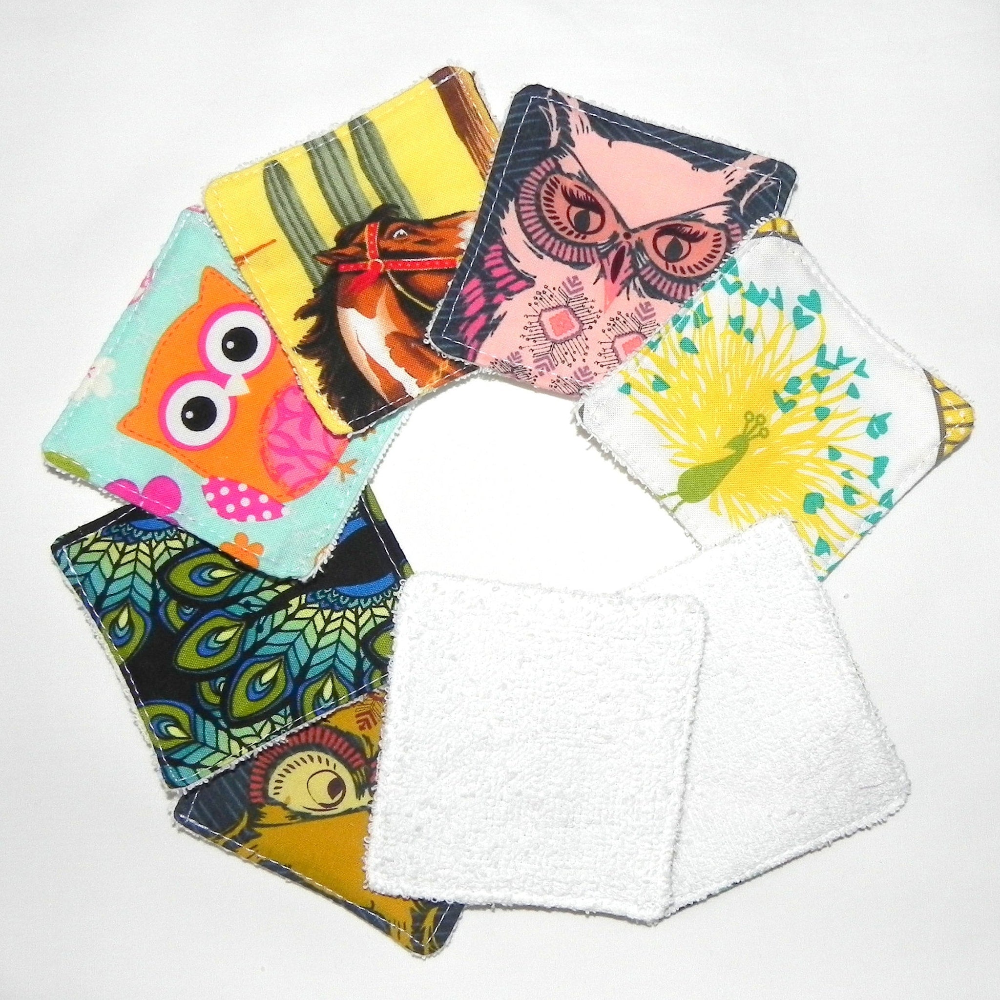 Cloth face scrubbies with various patterns and white terrycloth, arranged in a circle