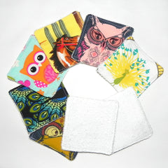 Cloth face scrubbies with various patterns and white terrycloth, arranged in a circle